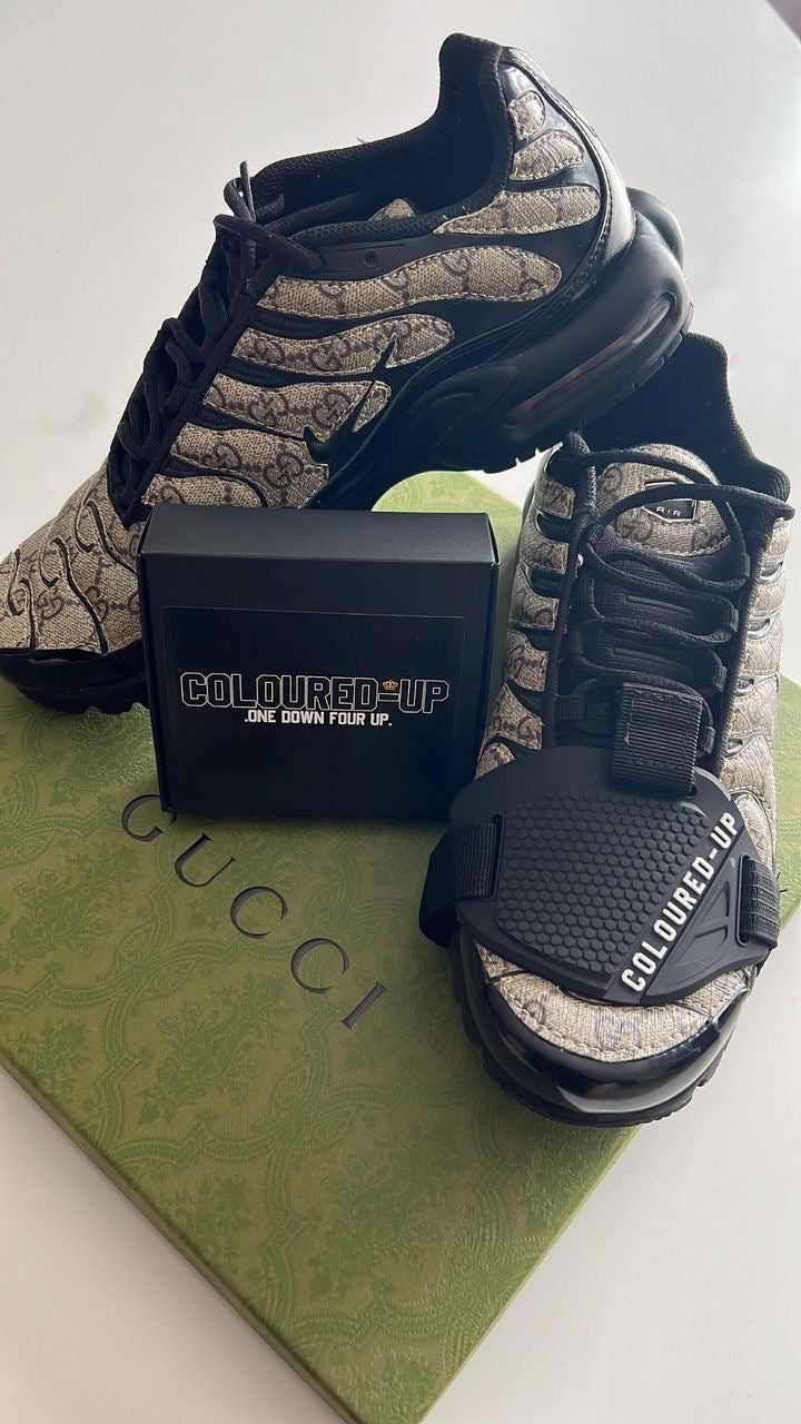 A pair of motorcycle rider gear protectors with a snake pattern, displayed alongside a black box with 'COLORDO' branding, placed on a green patterned surface.